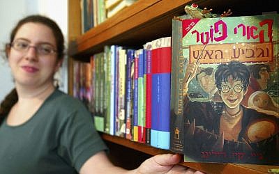 Gili Bar-Hillel with her Hebrew-language version of 'Harry Potter and the Goblet of Fire,' one of the four Harry Potter books she translated, in her Tel Aviv office, June 23, 2003. (David Silverman/Getty Images via JTA)