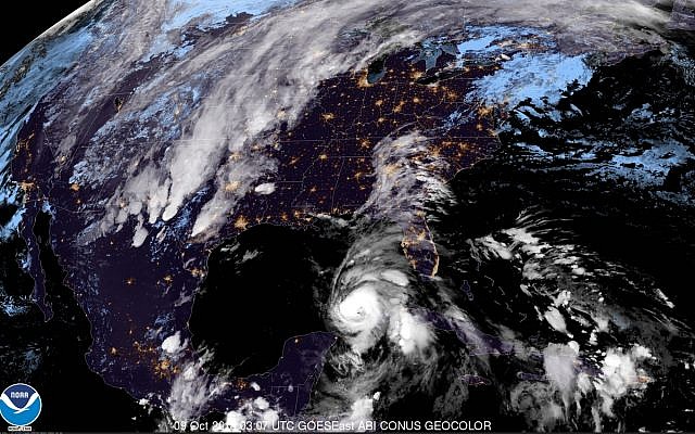 This satellite image provided by the National Oceanic and Atmospheric Administration shows a view of Tropical Storm Michael, lower right, churning as it heads toward the Florida Panhandle, early on October 9, 2018. (NOAA) This satellite image provided by the National Oceanic and Atmospheric Administration shows a view of Tropical Storm Michael, lower right, churning as it heads toward the Florida Panhandle, early on October 9, 2018. (NOAA)