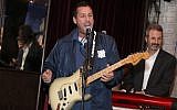 Adam Sandler plays at a benefit concert in Los Angeles, March 3, 2018 (Jerritt Clark/Getty Images for Artists for Peace and Justice via JTA)