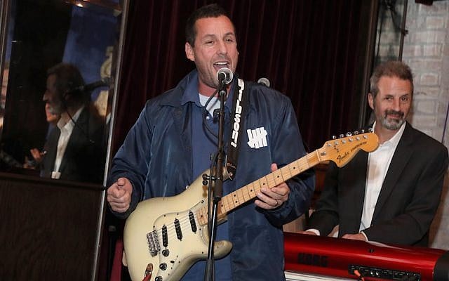 Adam Sandler plays at a benefit concert in Los Angeles, March 3, 2018 (Jerritt Clark/Getty Images for Artists for Peace and Justice via JTA) Adam Sandler plays at a benefit concert in Los Angeles, March 3, 2018 (Jerritt Clark/Getty Images for Artists for Peace and Justice via JTA)