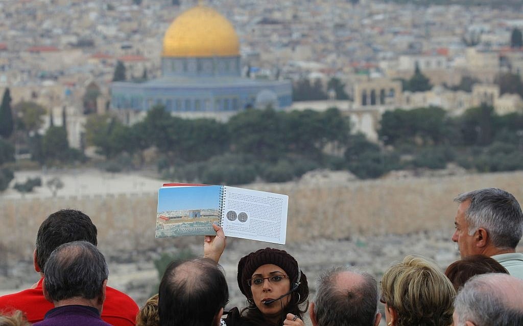 The Dome of the Rock in Jerusalem's Old City forms the backdrop to a tour guide holding up a picture of the ancient Jewish Temple. (Nati Shohat/FLASH90) The Dome of the Rock in Jerusalem's Old City forms the backdrop to a tour guide holding up a picture of the ancient Jewish Temple. (Nati Shohat/FLASH90)