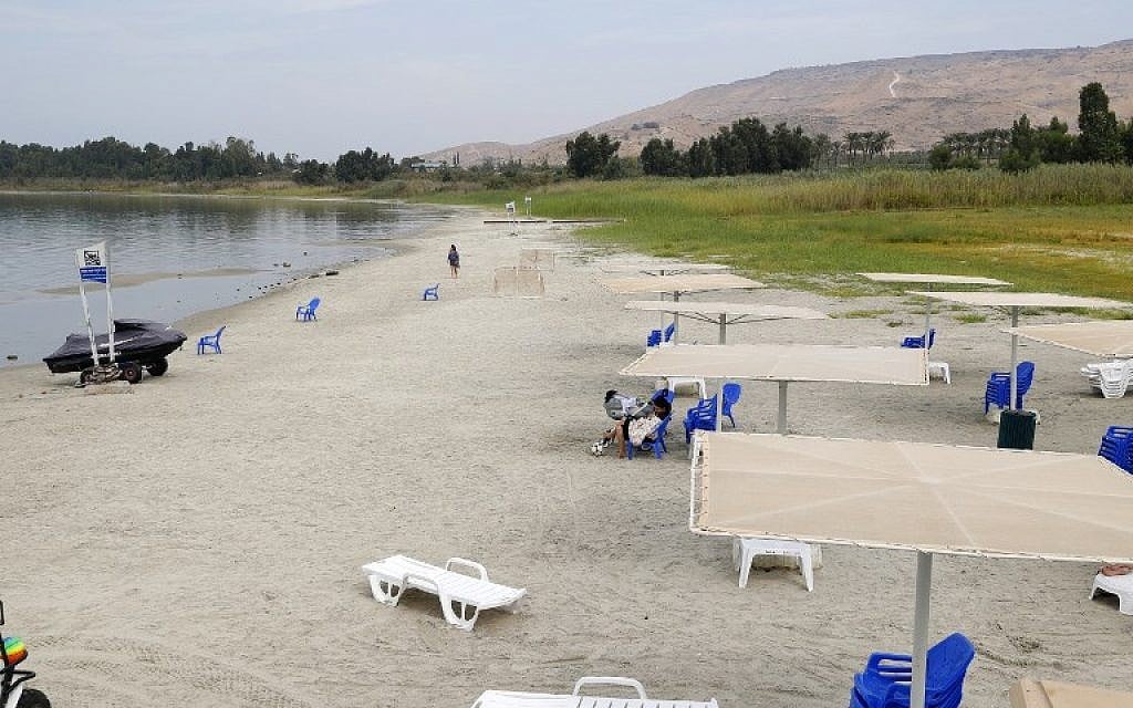 People sit on the beach of the Sea of Galilee near Kibbutz Ein-Gev, on October 8, 2018. (JACK GUEZ/AFP) People sit on the beach of the Sea of Galilee near Kibbutz Ein-Gev, on October 8, 2018. (JACK GUEZ/AFP)