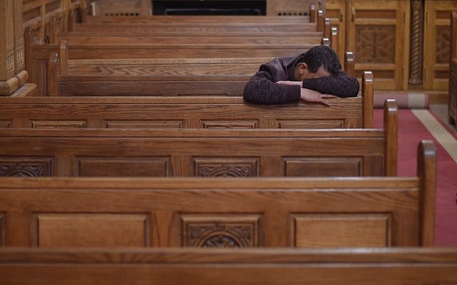 Illustrative: A Coptic Christian man mourns victims killed in an attack a day earlier, during an early morning ceremony at the Prince Tadros church in Egypt's southern Minya province, on November 3, 2018. (MOHAMED EL-SHAHED / AFP) Illustrative: A Coptic Christian man mourns victims killed in an attack a day earlier, during an early morning ceremony at the Prince Tadros church in Egypt's southern Minya province, on November 3, 2018. (MOHAMED EL-SHAHED / AFP)