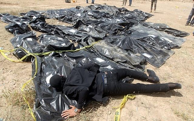 In this photo taken on April 12, 2015, an Iraqi man cries over body bags containing the remains of people believed to have been slain by Islamic State jihadists at the Speicher camp in the Iraqi city of Tikrit. (AHMAD AL-RUBAYE / AFP) In this photo taken on April 12, 2015, an Iraqi man cries over body bags containing the remains of people believed to have been slain by Islamic State jihadists at the Speicher camp in the Iraqi city of Tikrit. (AHMAD AL-RUBAYE / AFP)