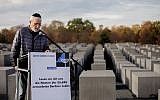 Gerhard Schmidt-Grillmeier reads names of 55,696 Jews from Berlin who were killed by the Nazis during a commemoration ceremony on November 8, 2018 at the Memorial to the Murdered Jews of Europe (Holocaust Memorial) in Berlin. (Photo by Christoph Soeder / dpa / AFP)