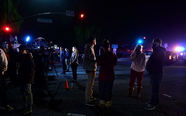 People stand and watch as the scene unfurls from the intersection of US 101 freeway and the Moorpark Rad exit as police vehicles close off the area outside a country music bar and dance hall in Thousand Oaks, west of Los Angeles, where a gunman opened fire late November 7, 2018, killing at least 12 people, US police said. (Photo by Frederic J. BROWN / AFP) People stand and watch as the scene unfurls from the intersection of US 101 freeway and the Moorpark Rad exit as police vehicles close off the area outside a country music bar and dance hall in Thousand Oaks, west of Los Angeles, where a gunman opened fire late November 7, 2018, killing at least 12 people, US police said. (Photo by Frederic J. BROWN / AFP)