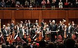 Pianist and conductor Daniel Barenboim (C) and the West-Eastern Divan Orchestra are seen at curtain call at the Kennedy Center for the Performing Arts in Washington, DC, on November 7, 2018. (Olivia Hampton/AFP)