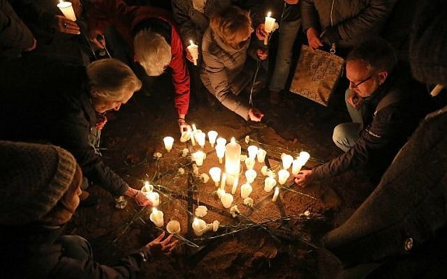 People light candles on November 8, 2018 at the site of a former synagogue in Schwerin as Germany marks the 80th anniversary of the 'Night of Broken Glass' (Kristallnacht) on November 9, 1938. (Bernd Wuestneck/dpa/AFP) People light candles on November 8, 2018 at the site of a former synagogue in Schwerin as Germany marks the 80th anniversary of the 'Night of Broken Glass' (Kristallnacht) on November 9, 1938. (Bernd Wuestneck/dpa/AFP)