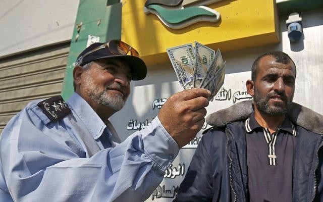 A Palestinian man shows his money after receiving his salary in Rafah in the southern Gaza Strip, November 9, 2018. (Said Khatib/AFP) A Palestinian man shows his money after receiving his salary in Rafah in the southern Gaza Strip, November 9, 2018. (Said Khatib/AFP)