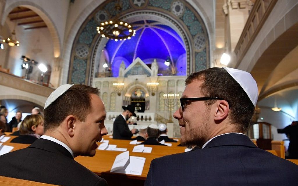 Illustrative: Guests attend a ceremony at the Synagogue Rykestrasse in Berlin on November 9, 2018, to commemorate the 80th anniversary of the Kristallnacht Nazi pogrom. (John MACDOUGALL / AFP)