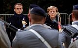French President Emmanuel Macron and German Chancellor Angela Merkel review troops during a French-German ceremony on November 10, 2018, in the Clairiere of Rethondes in Compiegne, northern France, as part of commemorations marking the 100th anniversary of the 11 November 1918 armistice. (PHILIPPE WOJAZER / POOL / AFP)