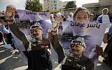 A girl holds a portrait of late leader Yasser Arafat as Palestinians celebrate the 14th anniversary of his death in the the West Bank city of Ramallah, on November 11, 2018. (ABBAS MOMANI/AFP)