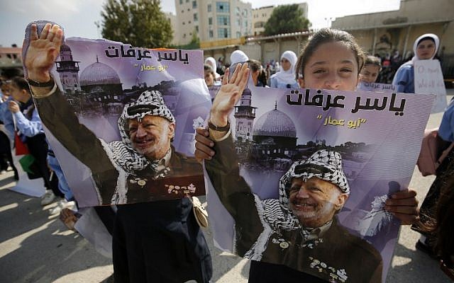 A girl holds a portrait of late leader Yasser Arafat as Palestinians celebrate the 14th anniversary of his death in the the West Bank city of Ramallah, on November 11, 2018. (ABBAS MOMANI/AFP) A girl holds a portrait of late leader Yasser Arafat as Palestinians celebrate the 14th anniversary of his death in the the West Bank city of Ramallah, on November 11, 2018. (ABBAS MOMANI/AFP)