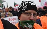 Supporter of the far-right movement Oboz Narodowo Radykalny (National Radical Camp) wearing a cape reading 'Anti-Antifa. Good night left side' attends the 'March of Independence,' on November 11, 2018, in Warsaw to mark 100 years of Polish independence. (Janek SKARZYNSKI / AFP)