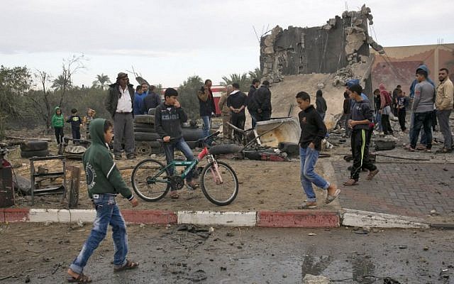 Palestinians stand next to the remains of a building, said to be destroyed in an Israeli airstrike, in Khan Younis in the southern Gaza Strip on November 12, 2018 (SAID KHATIB / AFP) Palestinians stand next to the remains of a building, said to be destroyed in an Israeli airstrike, in Khan Younis in the southern Gaza Strip on November 12, 2018 (SAID KHATIB / AFP)