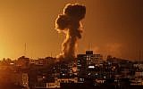 Illustrative: A picture taken on November 12, 2018, shows smoke rising above the building housing the Hamas-run television station al-Aqsa TV in the Gaza Strip during an Israeli air strike.  (Mahmud Hams / AFP)