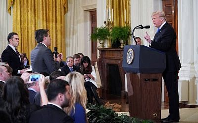 US President Donald Trump, right, gets into a heated exchange with CNN chief White House correspondent Jim Acosta, center, during a post-election press conference in the East Room of the White House in Washington, DC, November 7, 2018. (MANDEL NGAN/AFP)