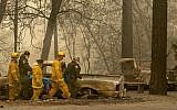 Rescue workers carry a body away from a burned property in the Holly Hills area of Paradise, California on November 14, 2018. (Josh Edelson / AFP)