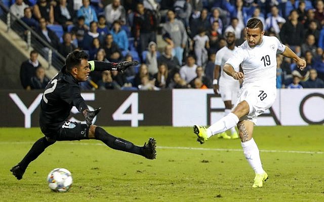 Israeli midfielder Dia Saba (R) shoots the ball past Guatemalan goalkeeper Paulo Motta to score in a FIFA friendly soccer match between Israel and Guatemala at Netanya Municipal Stadium on November 15, 2018. (Jack Guez/AFP)