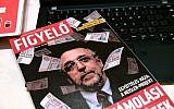 The cover of Hungarian magazine 'Figyelo' (Attention) with a portrait of Andras Heisler, head of the Federation of Hungarian Jewish Communities (Mazsihisz) is pictured on November 30, 2018, in Budapest. Hungary's largest Jewish organization has condemned  'incitement' against its leader after he was depicted on the cover of a prominent pro-government weekly surrounded by banknotes. (Attila Kisbenedek/AFP)
