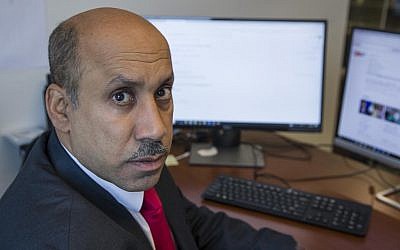 Ali AlAhmed poses for a photograph in his office Friday, Oct. 26, 2018, in Washington (AP Photo/Alex Brandon)