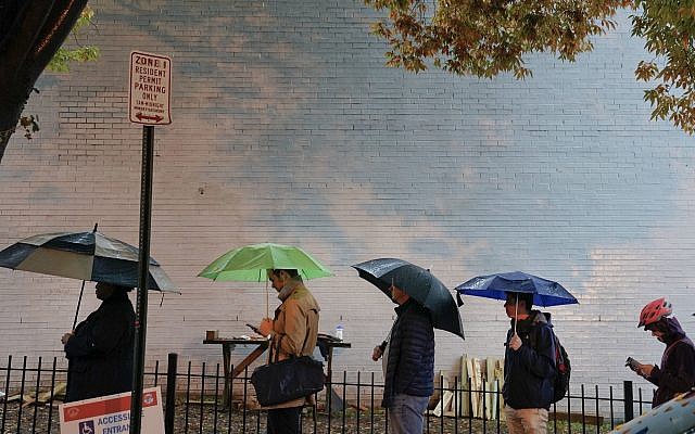 Voters line up in the rain outside Bright Family and Youth Center in the Columbia Heights neighborhood in Washington, Tuesday, Nov. 6, 2018. (AP/Pablo Martinez Monsivais)