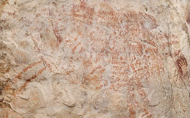 This composite image from the book "Borneo, Memory of the Caves" shows the world's oldest figurative artwork dated to a minimum of 40,000 years, in a limestone cave in the Indonesian part of the island of Borneo. (Luc-Henri age/kalimanthrope.com via AP) This composite image from the book "Borneo, Memory of the Caves" shows the world's oldest figurative artwork dated to a minimum of 40,000 years, in a limestone cave in the Indonesian part of the island of Borneo. (Luc-Henri age/kalimanthrope.com via AP)
