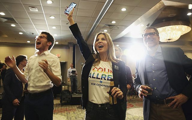 David Rosen, from left, Jennifer Karol and her husband Tom Karol react to an update on the 32nd Texas congressional race during an election night party for Democratic candidate Colin Allred at the Magnolia Hotel Dallas Park Cities in Dallas, Tuesday, Nov. 6, 2018. (AP Photo/Andy Jacobsohn) David Rosen, from left, Jennifer Karol and her husband Tom Karol react to an update on the 32nd Texas congressional race during an election night party for Democratic candidate Colin Allred at the Magnolia Hotel Dallas Park Cities in Dallas, Tuesday, Nov. 6, 2018. (AP Photo/Andy Jacobsohn)