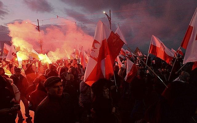 In this photo from November 11, 2017, demonstrators burn flares and wave Polish flags during the annual march to commemorate Poland's National Independence Day in Warsaw, Poland. (AP Photo/Czarek Sokolowski) In this photo from November 11, 2017, demonstrators burn flares and wave Polish flags during the annual march to commemorate Poland's National Independence Day in Warsaw, Poland. (AP Photo/Czarek Sokolowski)