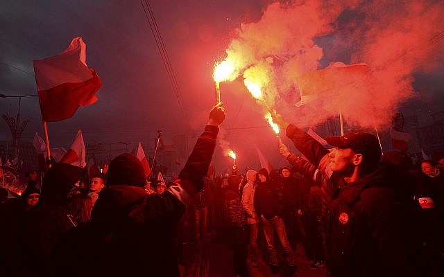 In this photo from November 11, 2017, demonstrators burn flares and wave Polish flags during the annual march to commemorate Poland's National Independence Day in Warsaw, Poland. (AP Photo/Czarek Sokolowski) In this photo from November 11, 2017, demonstrators burn flares and wave Polish flags during the annual march to commemorate Poland's National Independence Day in Warsaw, Poland. (AP Photo/Czarek Sokolowski)