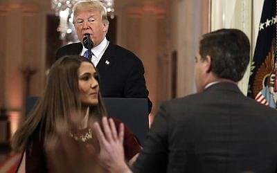 President Donald Trump looks on as a White House aide takes away a microphone from CNN journalist Jim Acosta during a news conference in the East Room of the White House, Wednesday, Nov. 7, 2018, in Washington. (AP Photo/Evan Vucci)
