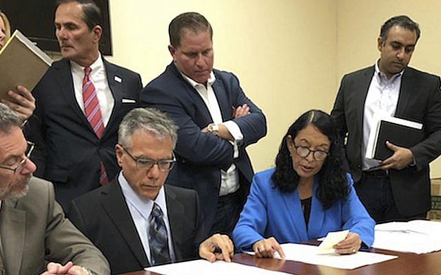Susan Bucher, second right, Palm Beach County Supervisor of Elections and Judge August Bonavita, seated at center left, look at provisional ballots in Riviera Beach, Fla., Friday, Nov. 9, 2018 (AP Photo/Josh Repogle) Susan Bucher, second right, Palm Beach County Supervisor of Elections and Judge August Bonavita, seated at center left, look at provisional ballots in Riviera Beach, Fla., Friday, Nov. 9, 2018 (AP Photo/Josh Repogle)