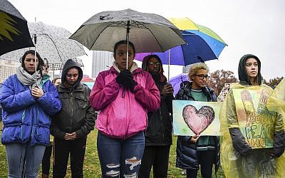 Attendees stand during a moment of silence during the Rally for Peace and Tree of Life Victims, Friday, November 9, 2018, at Point State Park in downtown Pittsburgh. (Alexandra Wimley/Pittsburgh Post-Gazette via AP)