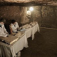 Archaeologists work on statues and artifacts inside a tomb, at an ancient necropolis near Egypt's famed pyramids in Saqqara, Giza, Egypt, November 10, 2018. (Nariman El-Mofty/AP)