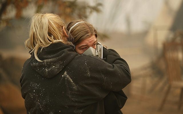 Krystin Harvey, left, comforts her daughter Araya Cipollini at the remains of their home burned in the Camp Fire, Saturday, Nov. 10, 2018, in Paradise, California. (AP/John Locher) Krystin Harvey, left, comforts her daughter Araya Cipollini at the remains of their home burned in the Camp Fire, Saturday, Nov. 10, 2018, in Paradise, California. (AP/John Locher)