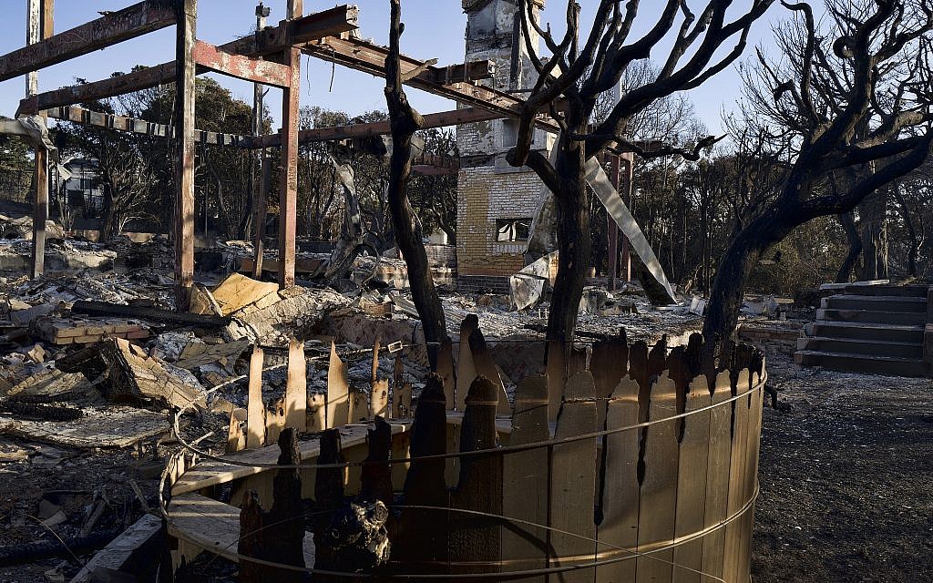A burned out hot tub and a fireplace are all that remains of a house in Point Dume, Malibu, California, November 11, 2018. (AP Photo/Richard Vogel)
