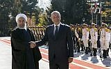 Iraqi President Barham Salih, right, and his Iranian counterpart Hassan Rouhani shake hands during an official welcome ceremony for Salih at the Saadabad Palace in Tehran, Iran, Saturday, November 17, 2018.  (Iranian Presidency Office via AP)
