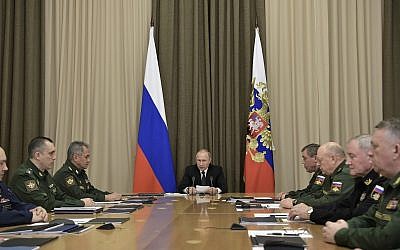 Russian President Vladimir Putin, background center, speaks during a meeting with top military officers in the Bocharov Ruchei residence in the Black Sea resort of Sochi, Russia on November 19, 2018. (Alexei Nikolsky, Sputnik, Kremlin Pool Photo via AP)