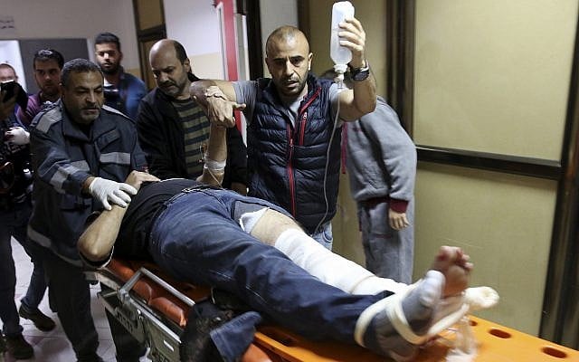 Colleagues wheel AP cameraman Rashed Rashid, 47, into a treatment room in Beit Lahiya in the northern Gaza Strip after he is shot in his left leg while covering a protest on the beach, November 19, 2018. (AP Photo/ Adel Hana) Colleagues wheel AP cameraman Rashed Rashid, 47, into a treatment room in Beit Lahiya in the northern Gaza Strip after he is shot in his left leg while covering a protest on the beach, November 19, 2018. (AP Photo/ Adel Hana)
