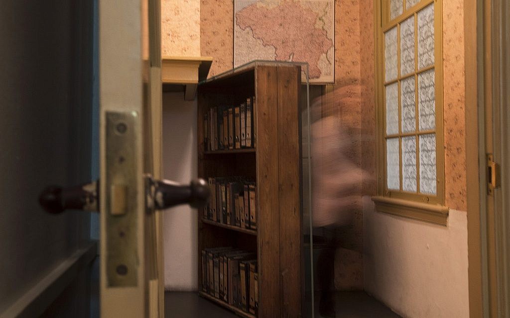 A museum employee emerges from the secret annex at the renovated Anne Frank House Museum in Amsterdam, Netherlands, Wednesday, Nov. 21, 2018. (AP Photo/Peter Dejong)