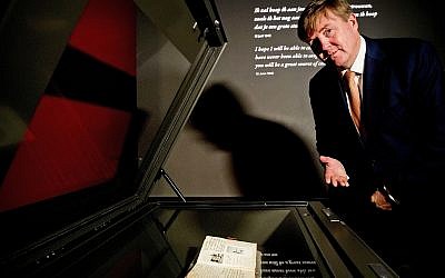 Dutch King Willem-Alexander looks at Anne Frank's diary displayed in the new Diary Room at the renovated Anne Frank House Museum in Amsterdam, Netherlands, Thursday, Nov. 22, 2018.(Patrick van Katwijk, pool photo via AP)