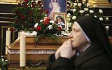 A nun prays beside the casket and photo of 110-year-old Roman Catholic Sister Cecylia Roszak, believed to be the world's oldest nun, and a rescuer of Jews during the Holocaust, during her funeral ceremonies at Church of Our Lady of the Snows the Dominican in Krakow, Poland, November 22, 2018. (AP Photo/Beata Zawrzel)