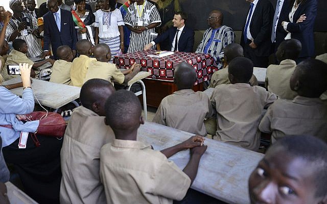 In this Tuesday, Nov. 28 , 2017 file photo French President Emmanuel Macron, center, and Burkina Faso's President Roch Marc Christian Kabore, center right, visit a school in Ouagadougou, Burkina Faso. (AP/Ahmed Yempabou Ouoba, File) In this Tuesday, Nov. 28 , 2017 file photo French President Emmanuel Macron, center, and Burkina Faso's President Roch Marc Christian Kabore, center right, visit a school in Ouagadougou, Burkina Faso. (AP/Ahmed Yempabou Ouoba, File)