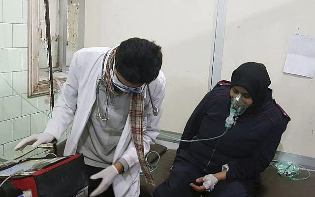 This photo released by the Syrian official news agency SANA shows a woman receiving oxygen through respirators following a suspected chemical attack on her town of al-Khalidiya, in Aleppo, Syria, Saturday, Nov. 24, 2018. (SANA via AP) This photo released by the Syrian official news agency SANA shows a woman receiving oxygen through respirators following a suspected chemical attack on her town of al-Khalidiya, in Aleppo, Syria, Saturday, Nov. 24, 2018. (SANA via AP)