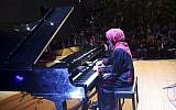 Palestinian pianist Yara Thabit plays the piano during a concert to mark the debut of Gaza's only grand piano after it was rescued from conflict, at a theater nestled in the Palestinian Red Crescent Society's building in Gaza City on Nov. 25, 2018. (AP Photo/Adel Hana)