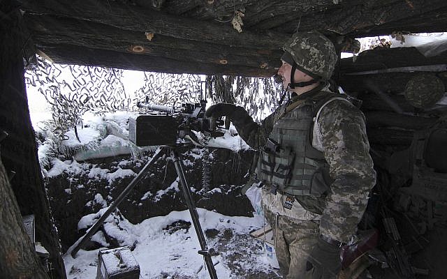 A Ukraine army soldier stands on duty with his heavy machine gun at an undisclosed location in eastern Ukraine, November 26, 2018. (Alexander Shulman/AP)