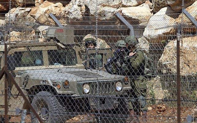 Israeli soldiers patrols near the area where Hezbollah held a rally to mark al-Quds (Jerusalem) Day, at the village of Maroun el-Rass on the Lebanon-Israel border, June 8, 2018. (AP/Mohammed Zaatari, File) Israeli soldiers patrols near the area where Hezbollah held a rally to mark al-Quds (Jerusalem) Day, at the village of Maroun el-Rass on the Lebanon-Israel border, June 8, 2018. (AP/Mohammed Zaatari, File)
