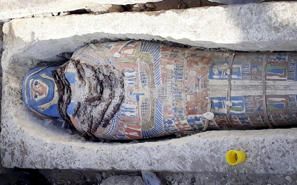 Illustrative - This undated photo released by the Egyptian Ministry of Antiquities on Wednesday, Nov. 28, 2018, shows an ancient mummy covered with a layer of painted cartonnage, which was found inside a sarcophagus in area of King Amenemhat II's pyramid in the Dahshur royal necropolis, about 25 miles south of Cairo. Egypt says archaeologists have discovered eight limestone sarcophagi with mummies inside. (Egyptian Ministry of Antiquities via AP)