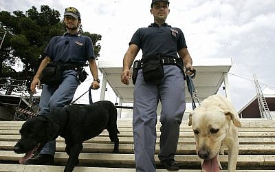 Illustrative: Two Italian explosive police experts walk their sniffer dogs on the stairs of the sanctuary of Madonna di Bonaria in Cagliari, Sardinia, Italy, Saturday, Sept. 6, 2008. (AP/Pier Paolo Cito)