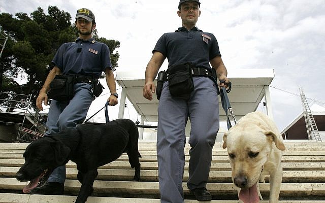 Illustrative: Two Italian explosive police experts walk their sniffer dogs on the stairs of the sanctuary of Madonna di Bonaria in Cagliari, Sardinia, Italy, Saturday, Sept. 6, 2008. (AP/Pier Paolo Cito) Illustrative: Two Italian explosive police experts walk their sniffer dogs on the stairs of the sanctuary of Madonna di Bonaria in Cagliari, Sardinia, Italy, Saturday, Sept. 6, 2008. (AP/Pier Paolo Cito)